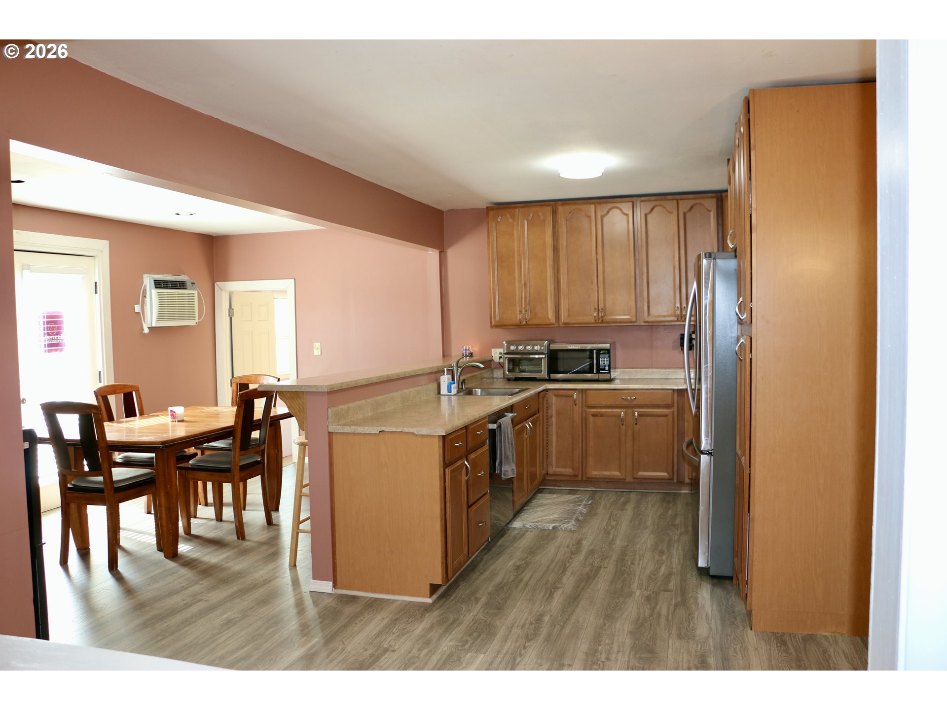 400 West 6th Street The Dalles, OR 97058 - Photo 15 of 28 a kitchen with a sink cabinets and wooden floor