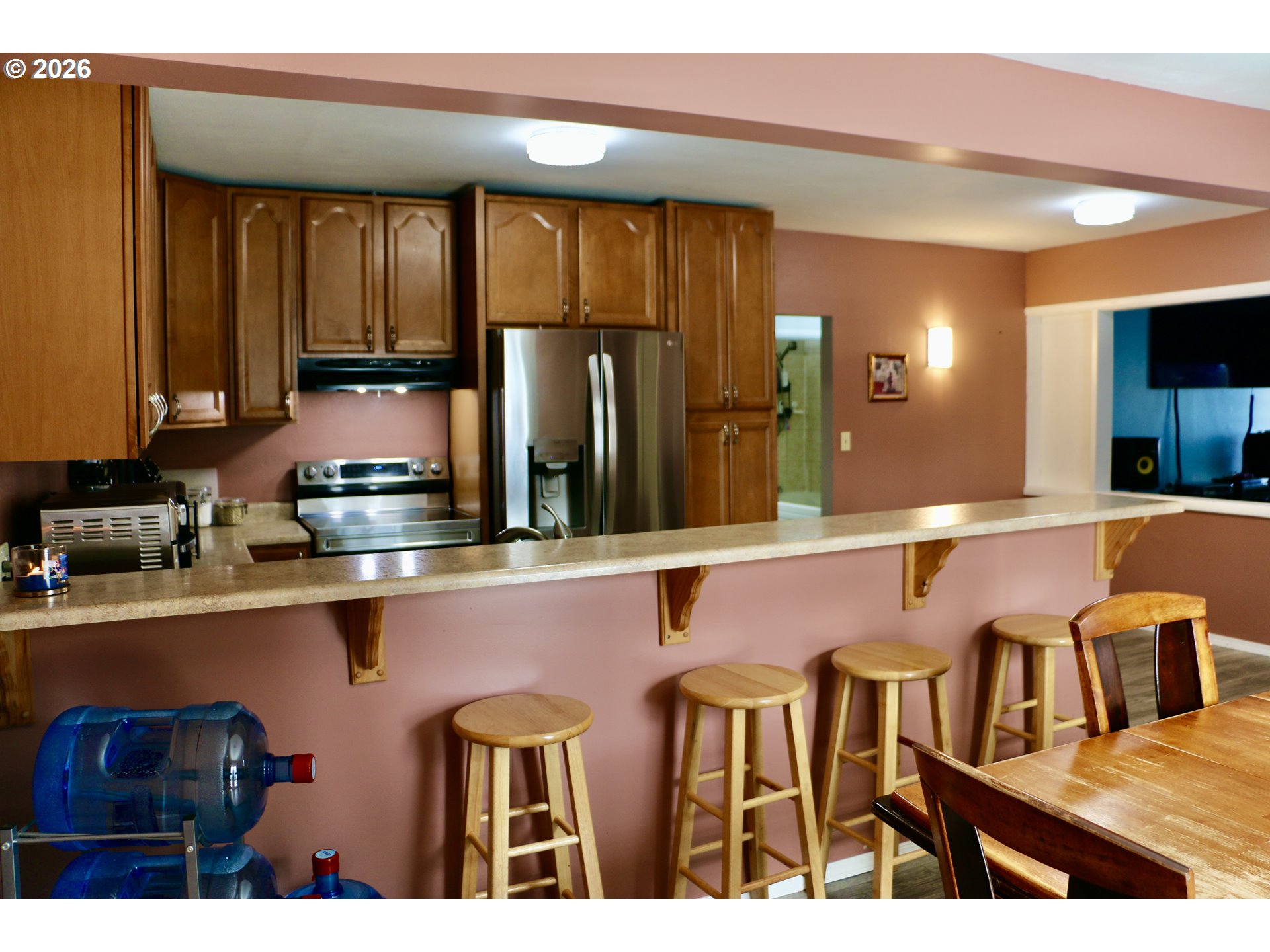 400 West 6th Street The Dalles, OR 97058 - Photo 16 of 28 a kitchen with a table chairs refrigerator and cabinets