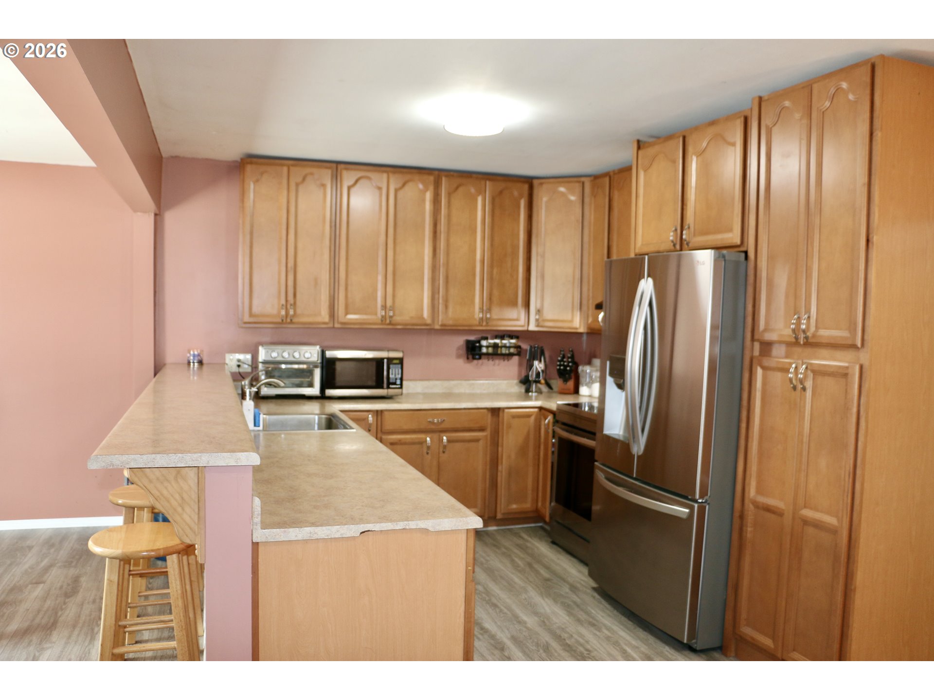 400 West 6th Street The Dalles, OR 97058 - Photo 17 of 28 a kitchen with a refrigerator a stove a sink and a window