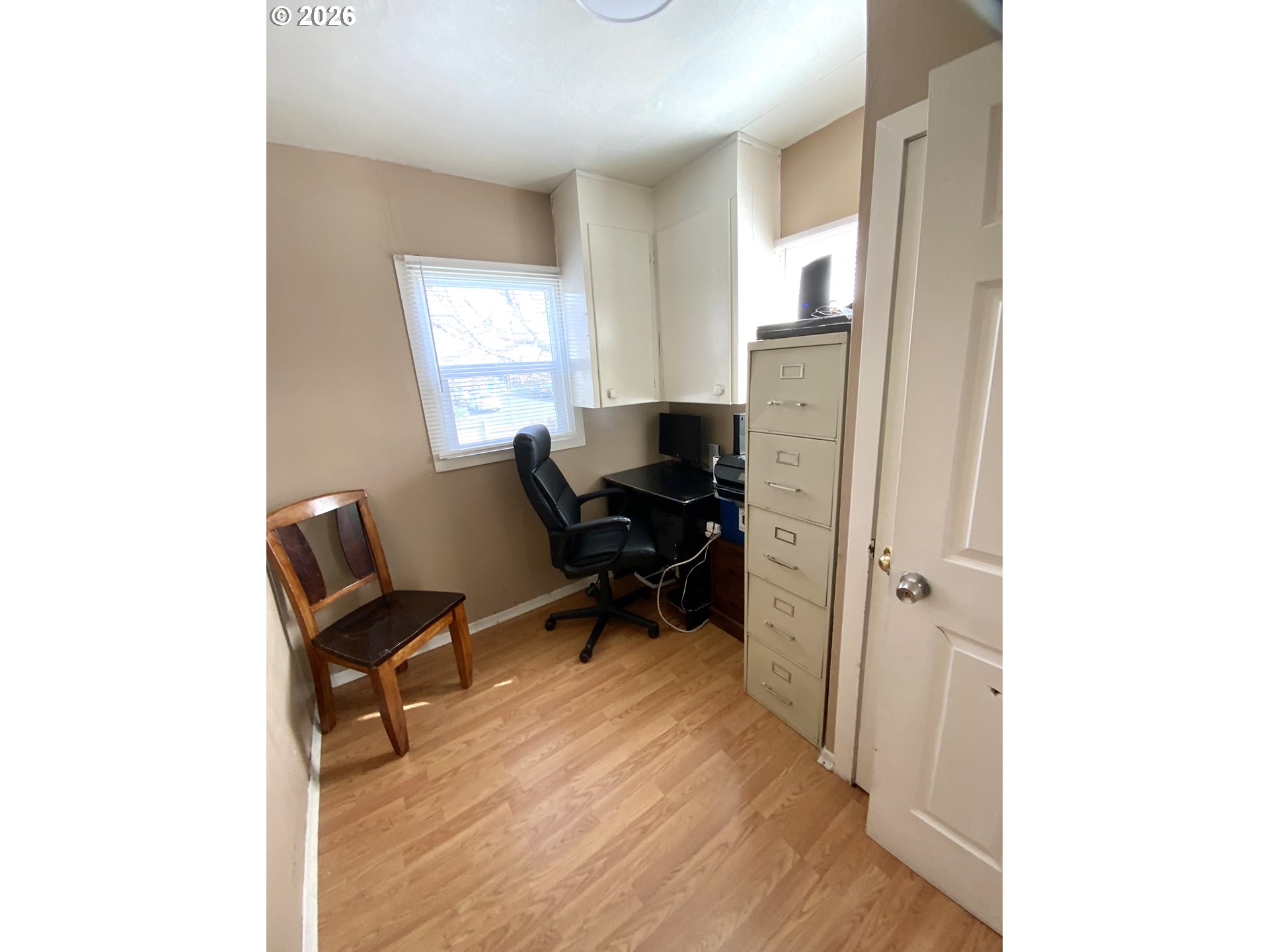 400 West 6th Street The Dalles, OR 97058 - Photo 20 of 28 a view of a workspace room with wooden floor furniture and a window