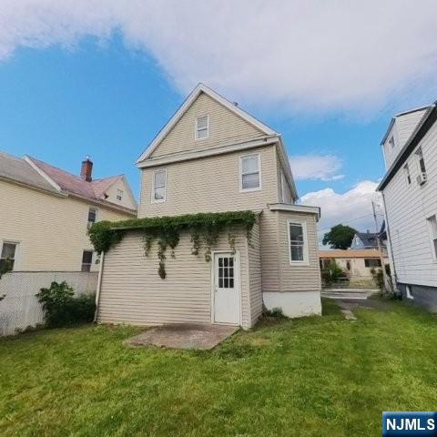 167 James Street Hackensack, NJ 07601 - Photo 7 of 30 a front view of a house with a yard and garage