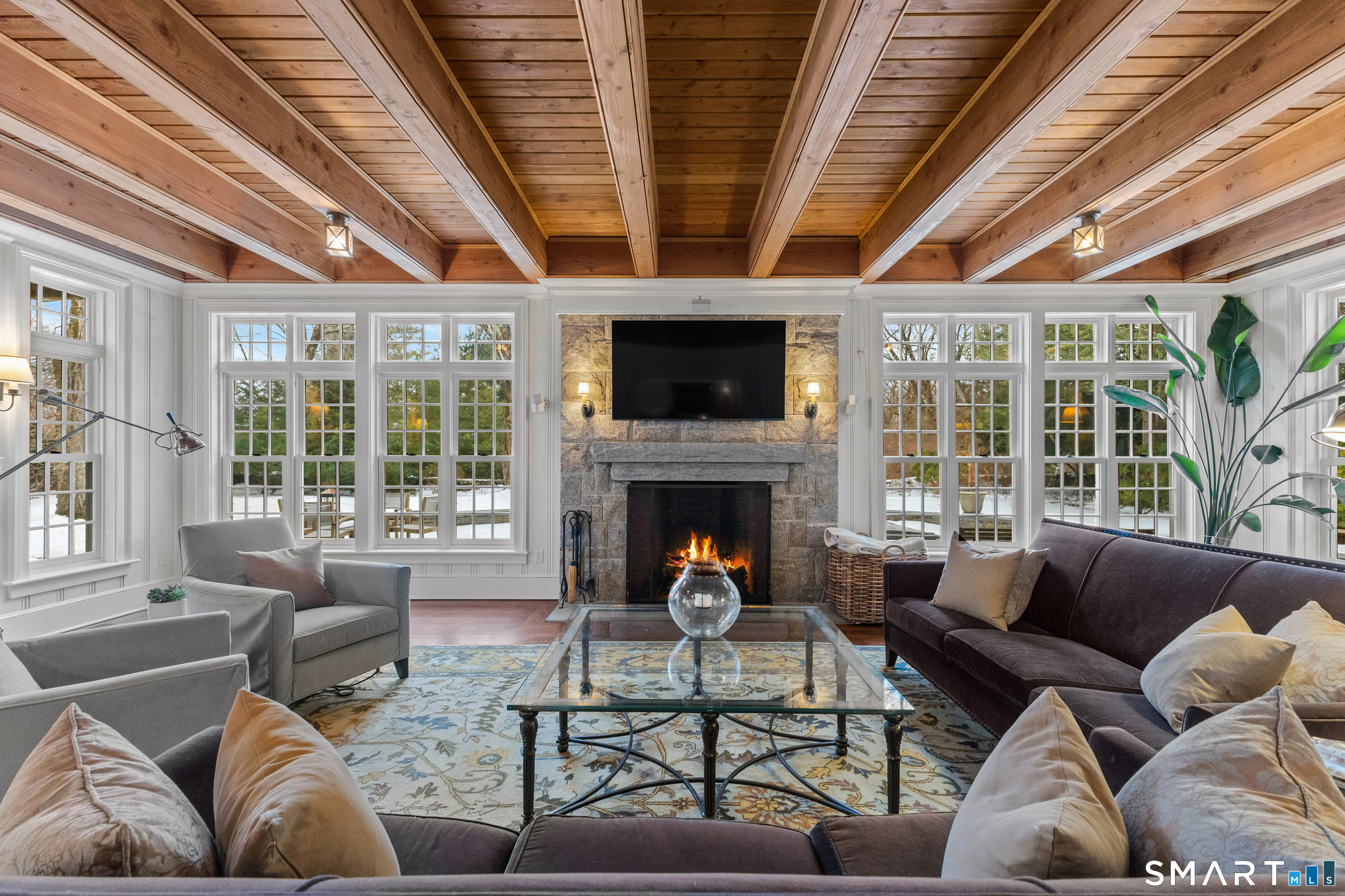 422 Scofieldtown Road Stamford, CT 06903 - Photo 12 of 38 a living room with furniture a fireplace and a large window
