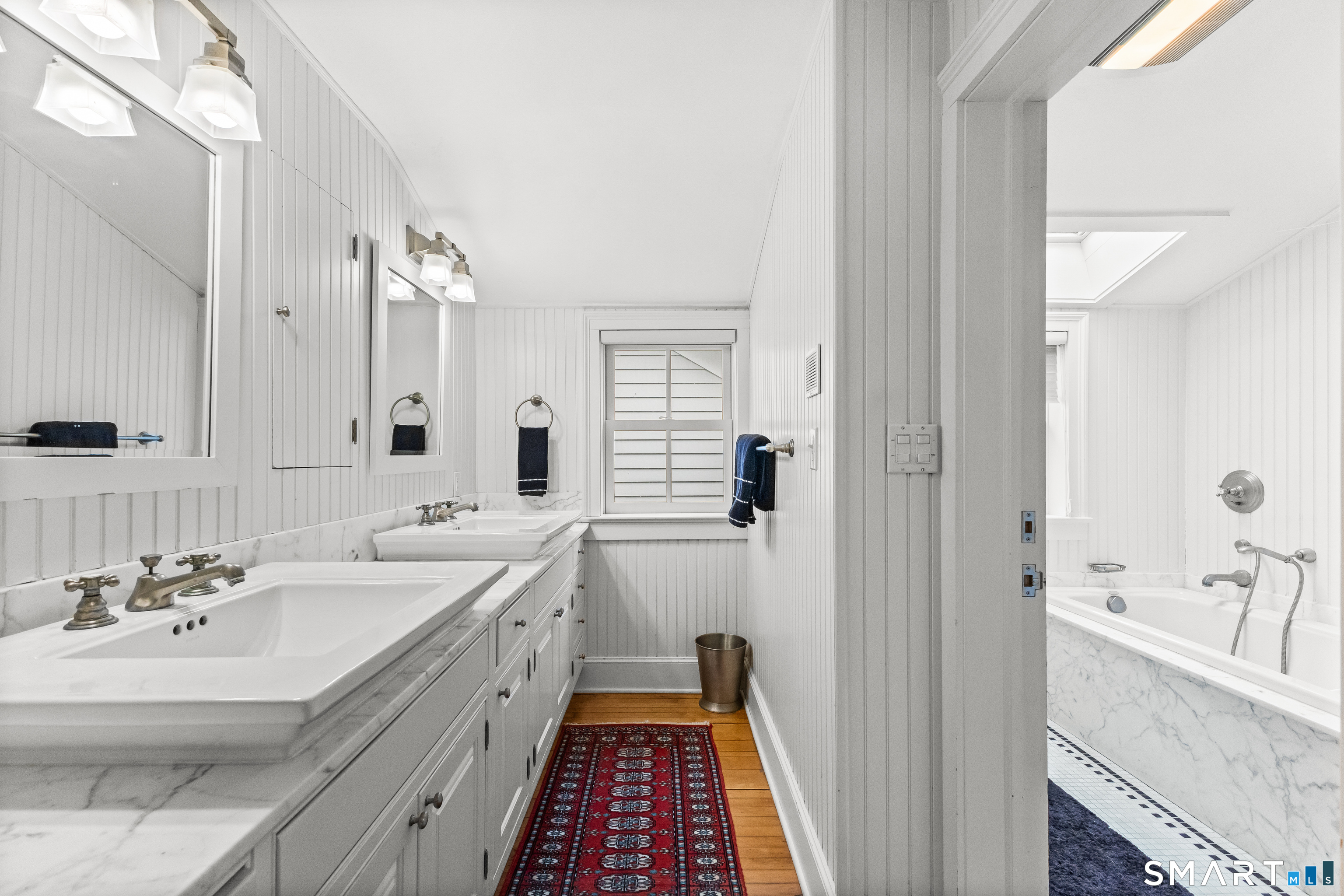 422 Scofieldtown Road Stamford, CT 06903 - Photo 28 of 38 a spacious bathroom with a double vanity sink a mirror and a bathtub