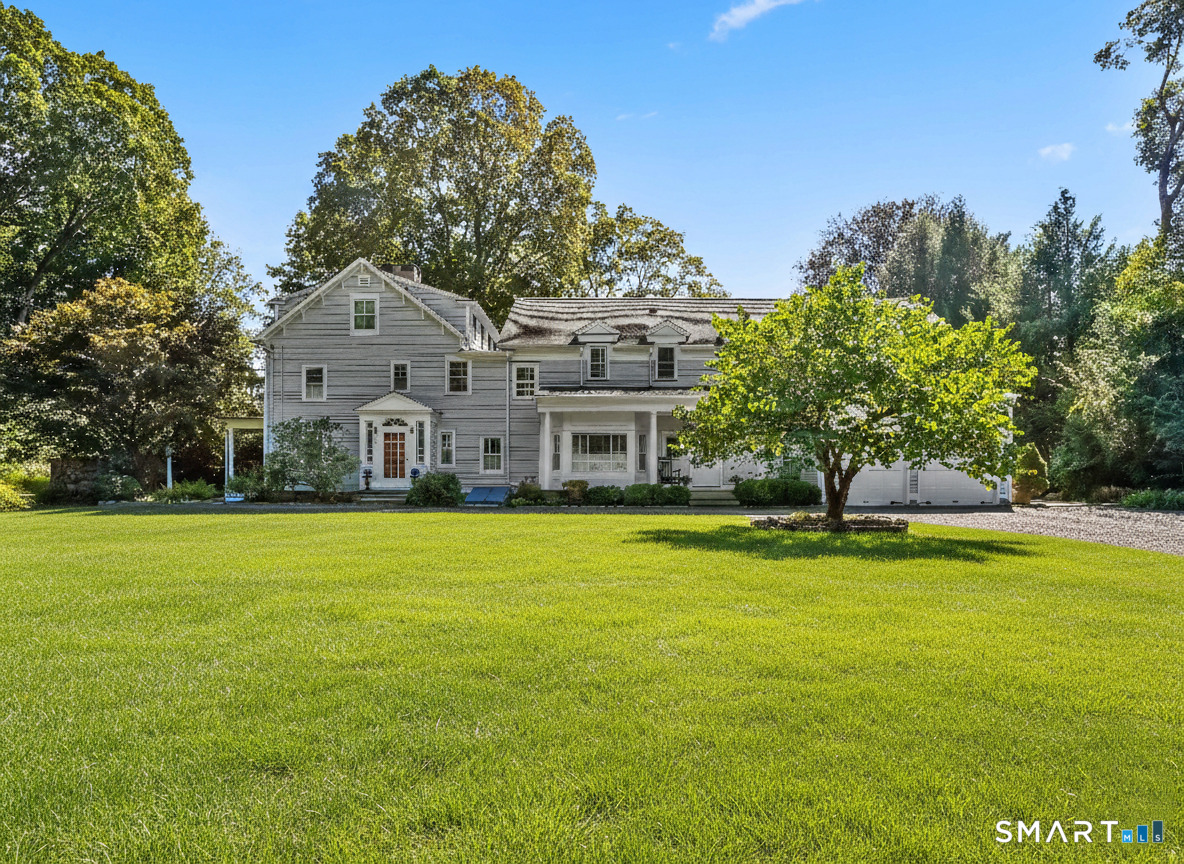 422 Scofieldtown Road Stamford, CT 06903 - Photo 3 of 38 a front view of a house with a garden
