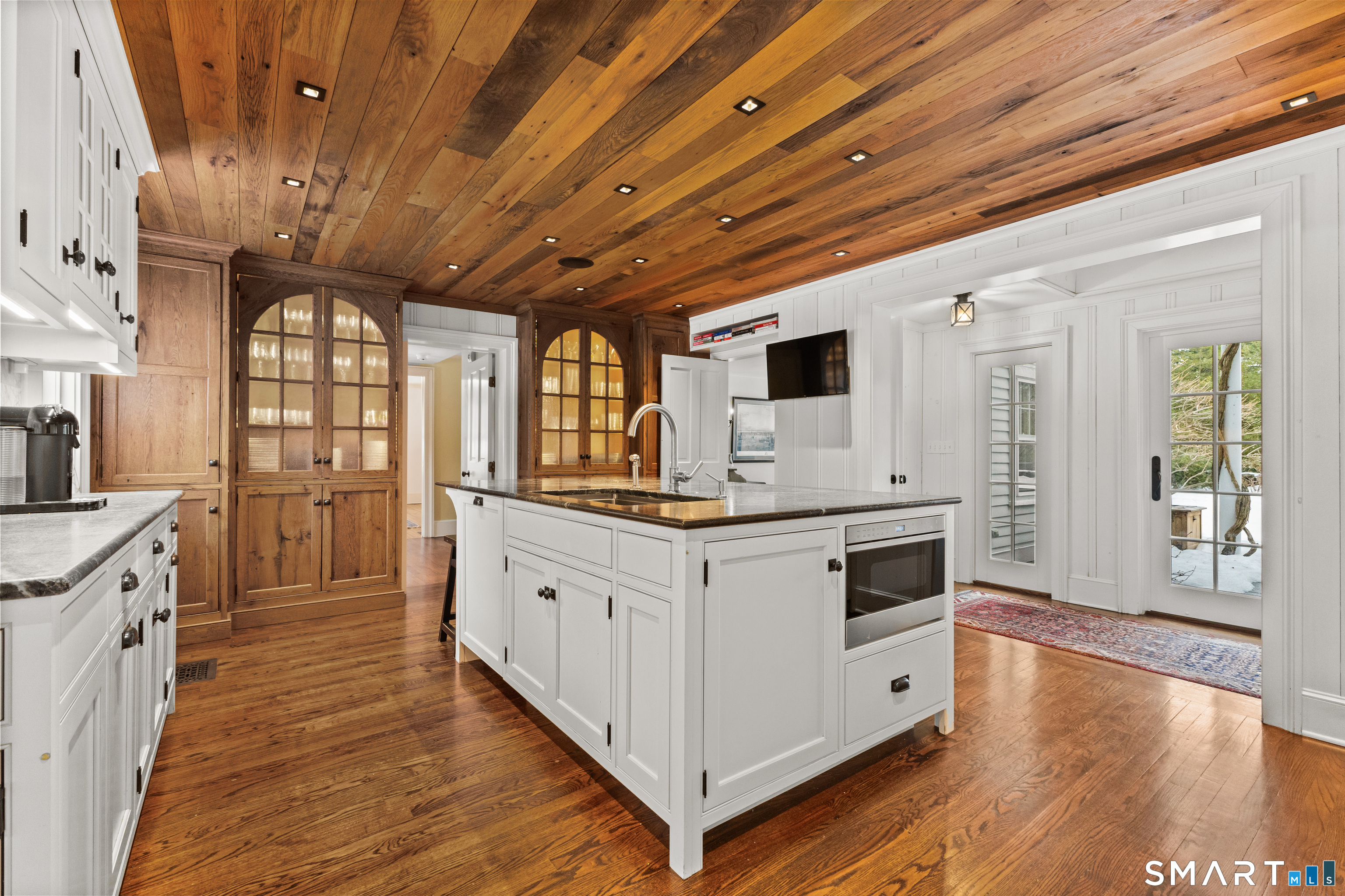 422 Scofieldtown Road Stamford, CT 06903 - Photo 8 of 38 a large kitchen with stainless steel appliances granite countertop a large stove a sink dishwasher and white cabinets with wooden floor