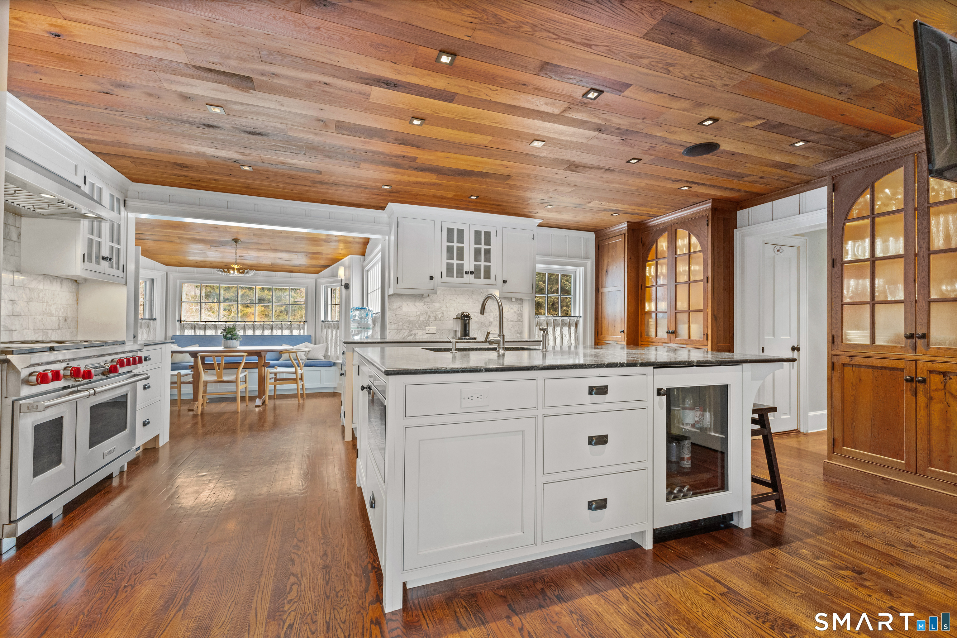 422 Scofieldtown Road Stamford, CT 06903 - Photo 9 of 38 a kitchen with stainless steel appliances a stove and wooden floor