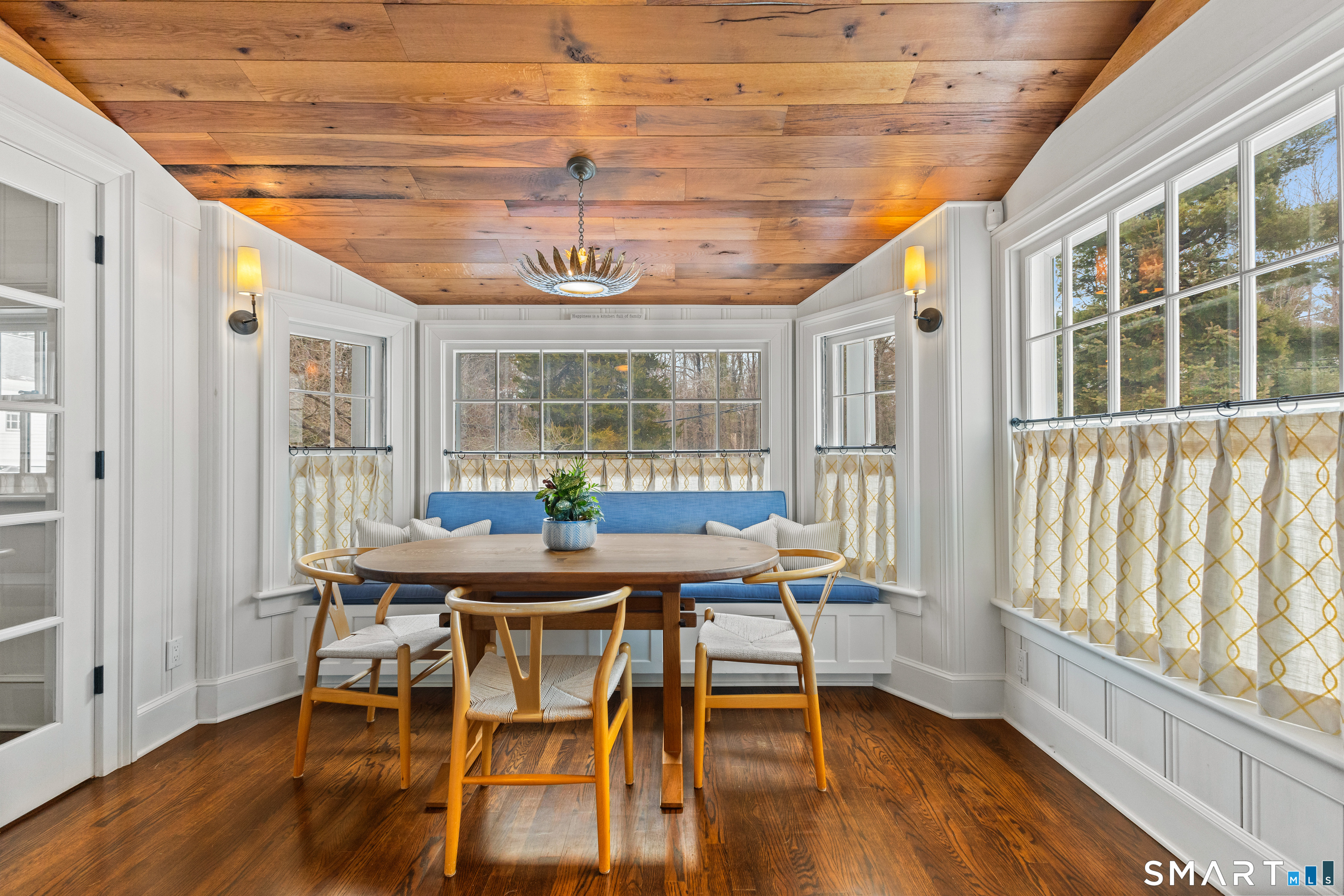 422 Scofieldtown Road Stamford, CT 06903 - Photo 10 of 38 a dining room with furniture a chandelier and wooden floor