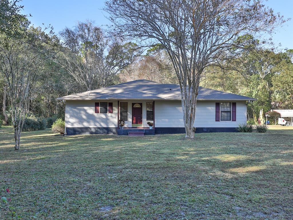 2208 Marsh Road DeLand, FL 32724 - Photo 1 of 1 a front view of a house with a garden