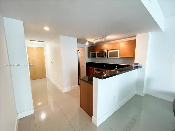 a kitchen with a sink and a refrigerator
