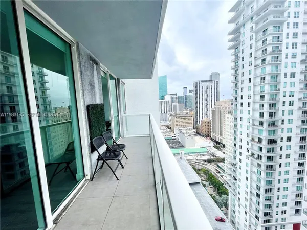 a view of a balcony and chairs and wooden floor