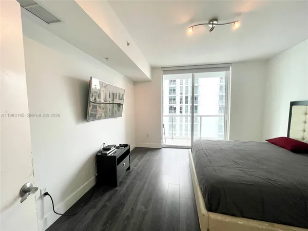 a bathroom with a granite countertop sink a toilet and mirror