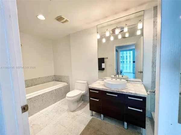 a view of a swimming pool with a lounge chair and palm trees