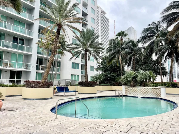 a swimming pool with outdoor seating and yard