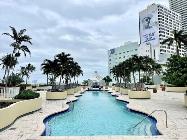 a swimming pool with outdoor seating and lake view