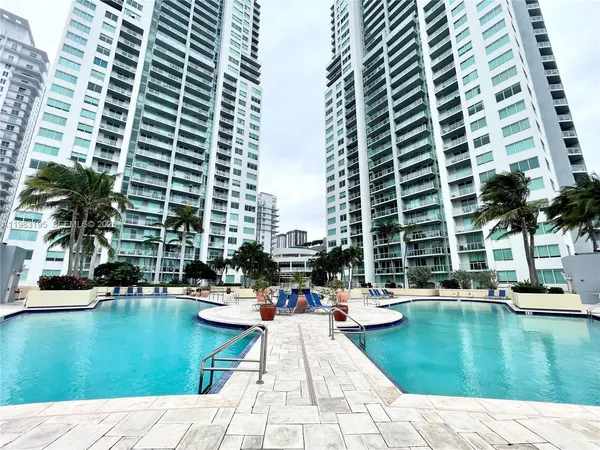 a bathroom with a granite countertop shower a mirror and a sink