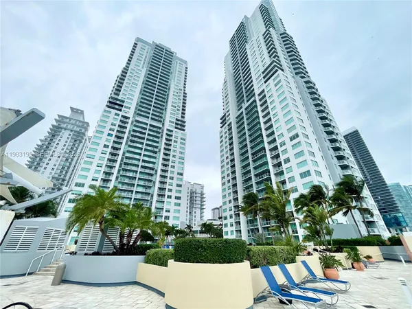 a kitchen with a table chairs sink and cabinets
