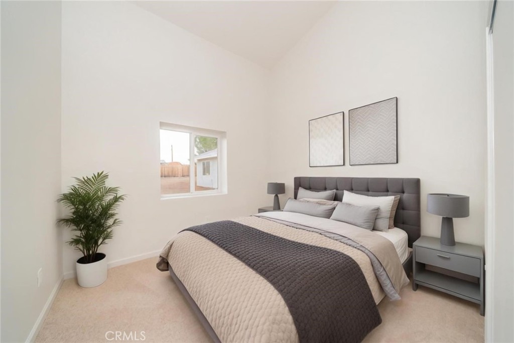 16754 Pauhaska Road Apple Valley, CA 92307 - Photo 11 of 19 a bedroom with a bed and a potted plant