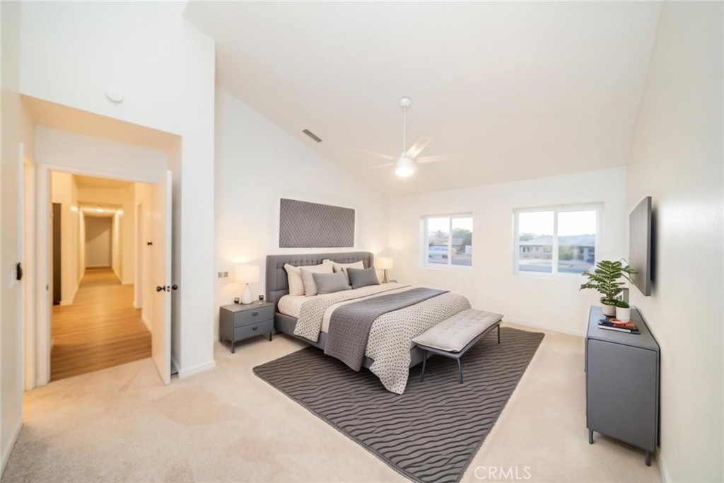 16754 Pauhaska Road Apple Valley, CA 92307 - Photo 12 of 19 a bedroom with a large bed couch and a potted plant