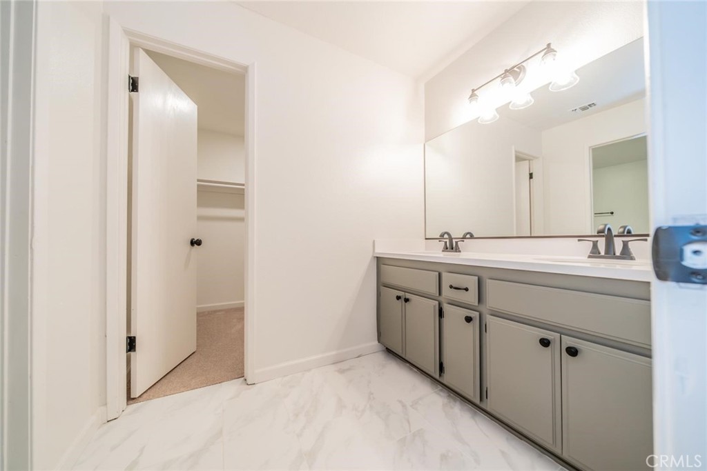 16754 Pauhaska Road Apple Valley, CA 92307 - Photo 13 of 19 a spacious bathroom with a double vanity sink mirror and