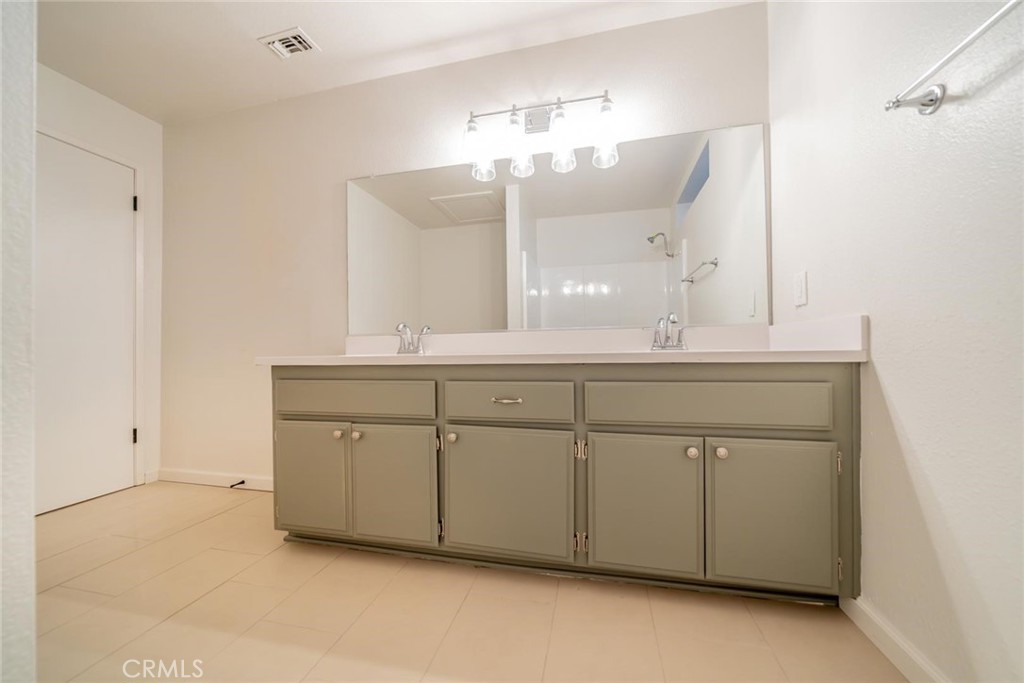 16754 Pauhaska Road Apple Valley, CA 92307 - Photo 9 of 19 a bathroom with a double vanity sink mirror and