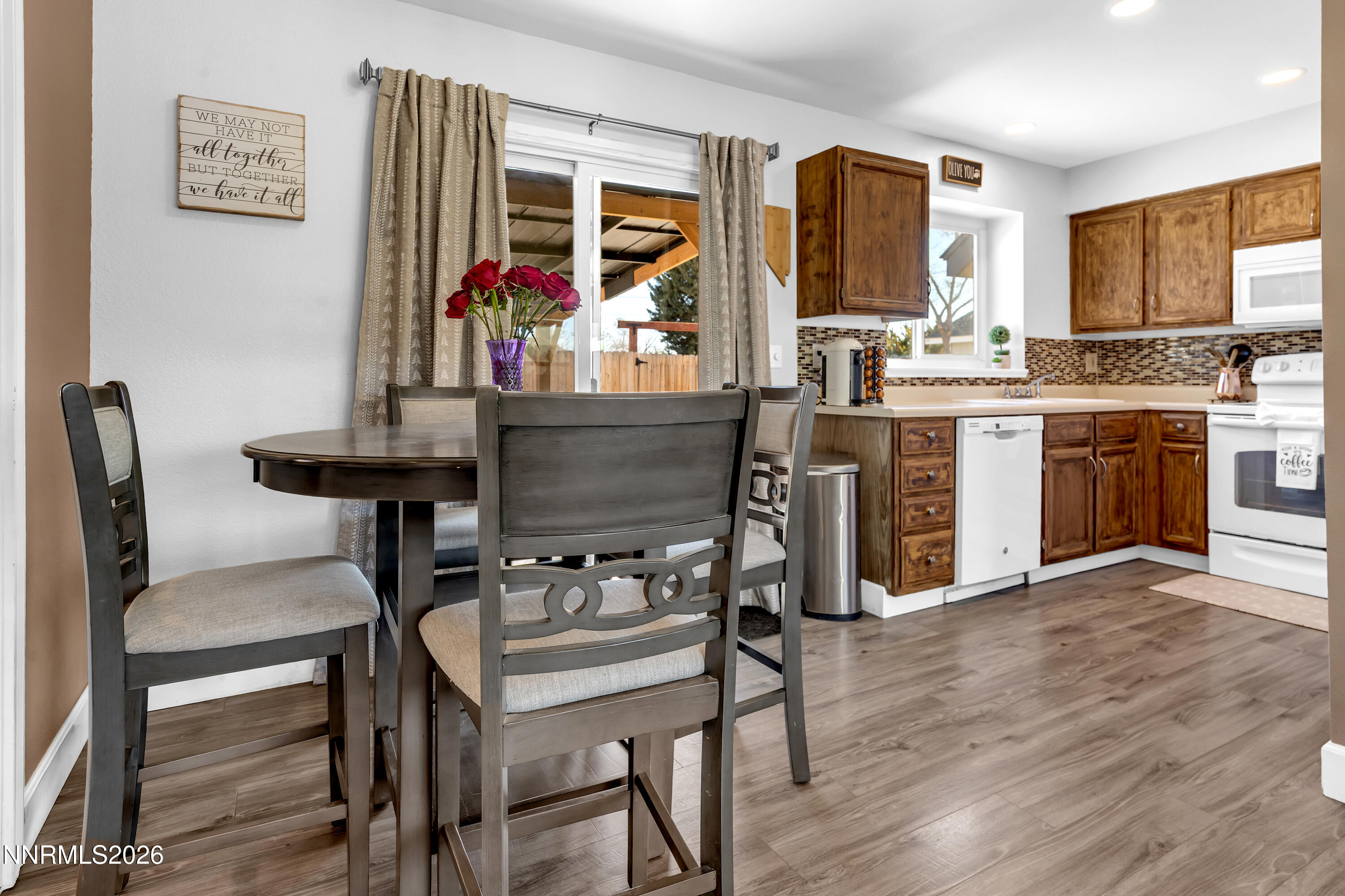 480 Aswan Street Sparks, NV 89441 - Photo 18 of 41 a kitchen with stainless steel appliances kitchen island granite countertop a table chairs sink and cabinets