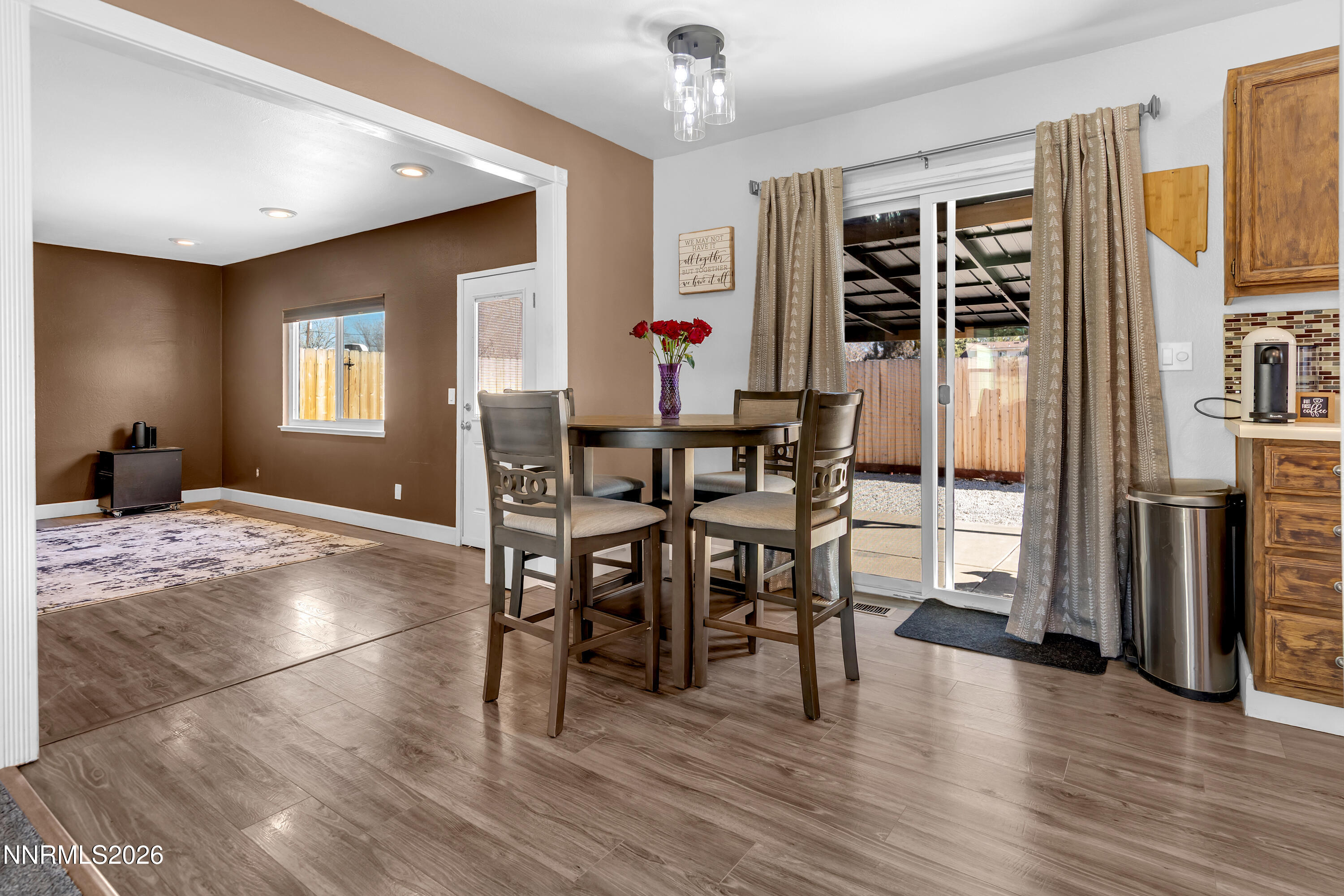 480 Aswan Street Sparks, NV 89441 - Photo 22 of 41 a dining room with wooden floor a chandelier a glass table and chairs