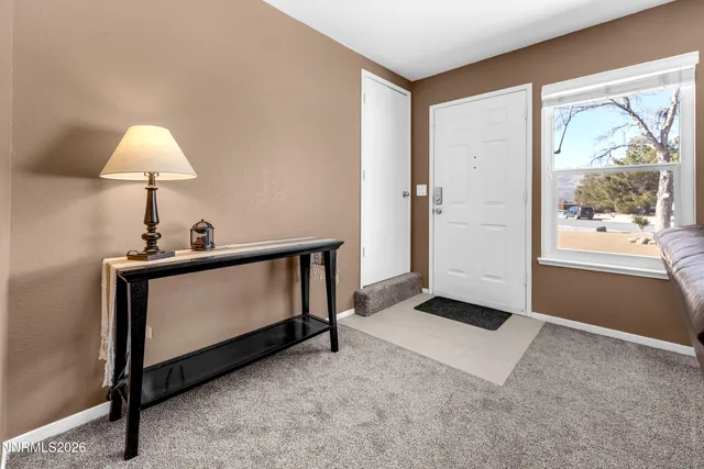 a living room with a bed furniture and a window