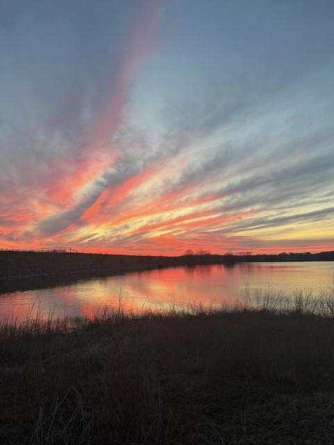 2077 A Shawver Road Perrin, TX 76486 - Photo 26 of 35 Expansive water feature with a vibrant, colorful sky