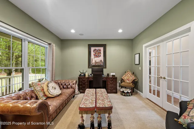 a bedroom with a bed a mirror and furniture