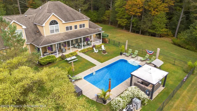 a view of a chair and tables in the patio in front of a house