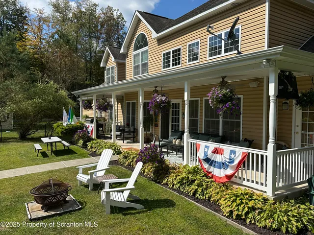 a view of a house with swimming pool and porch