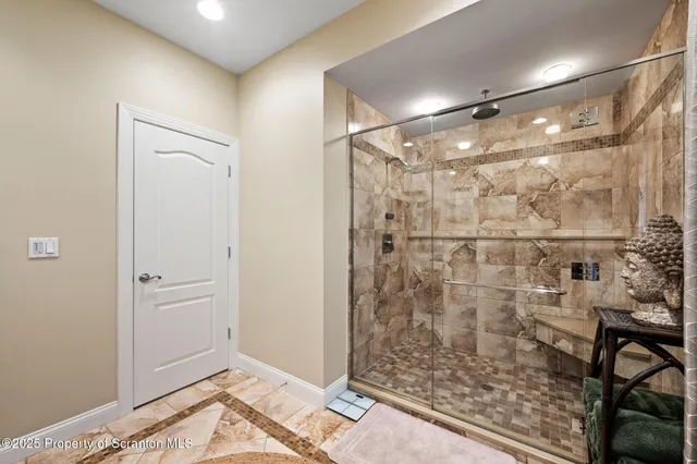 a view of a house with swimming pool and chairs