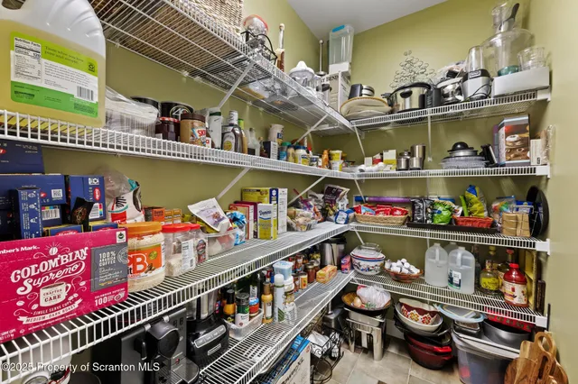 a view of pool with lawn chairs under an umbrella