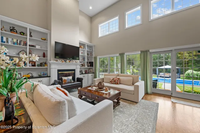 a view of a hallway with furniture and wooden floor