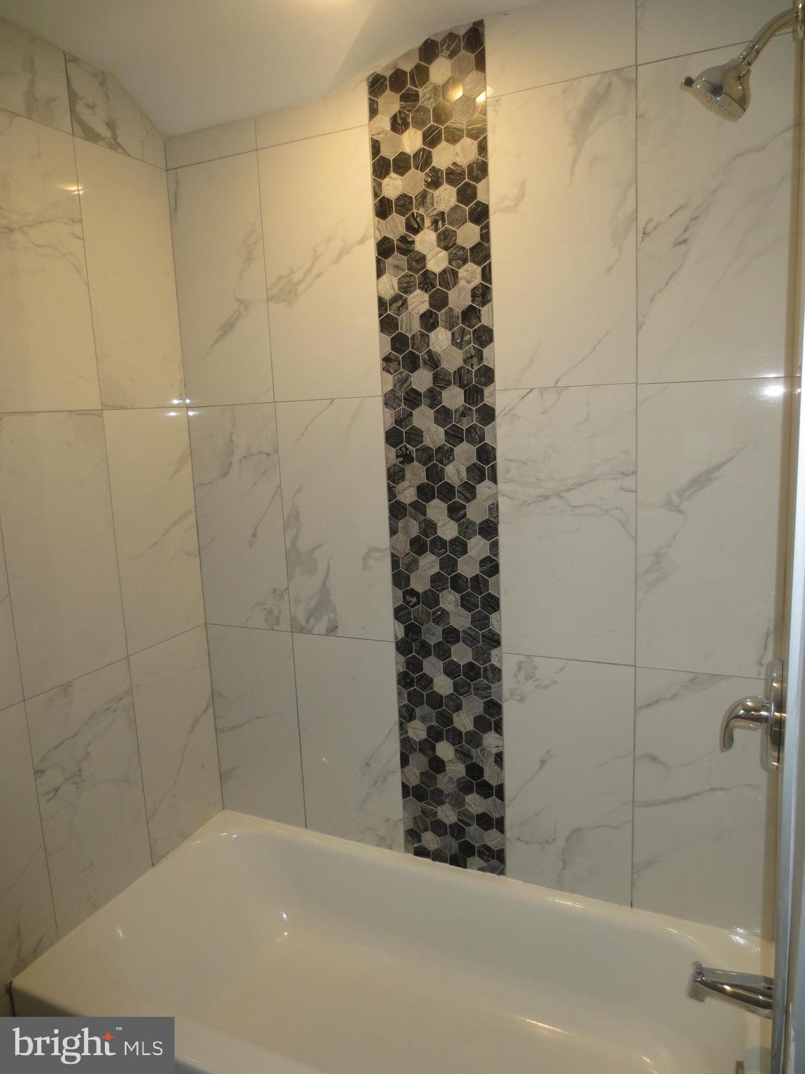 2027 Ramblewood Road Baltimore, MD 21239 - Photo 17 of 17 a bathroom with a bathtub and shower