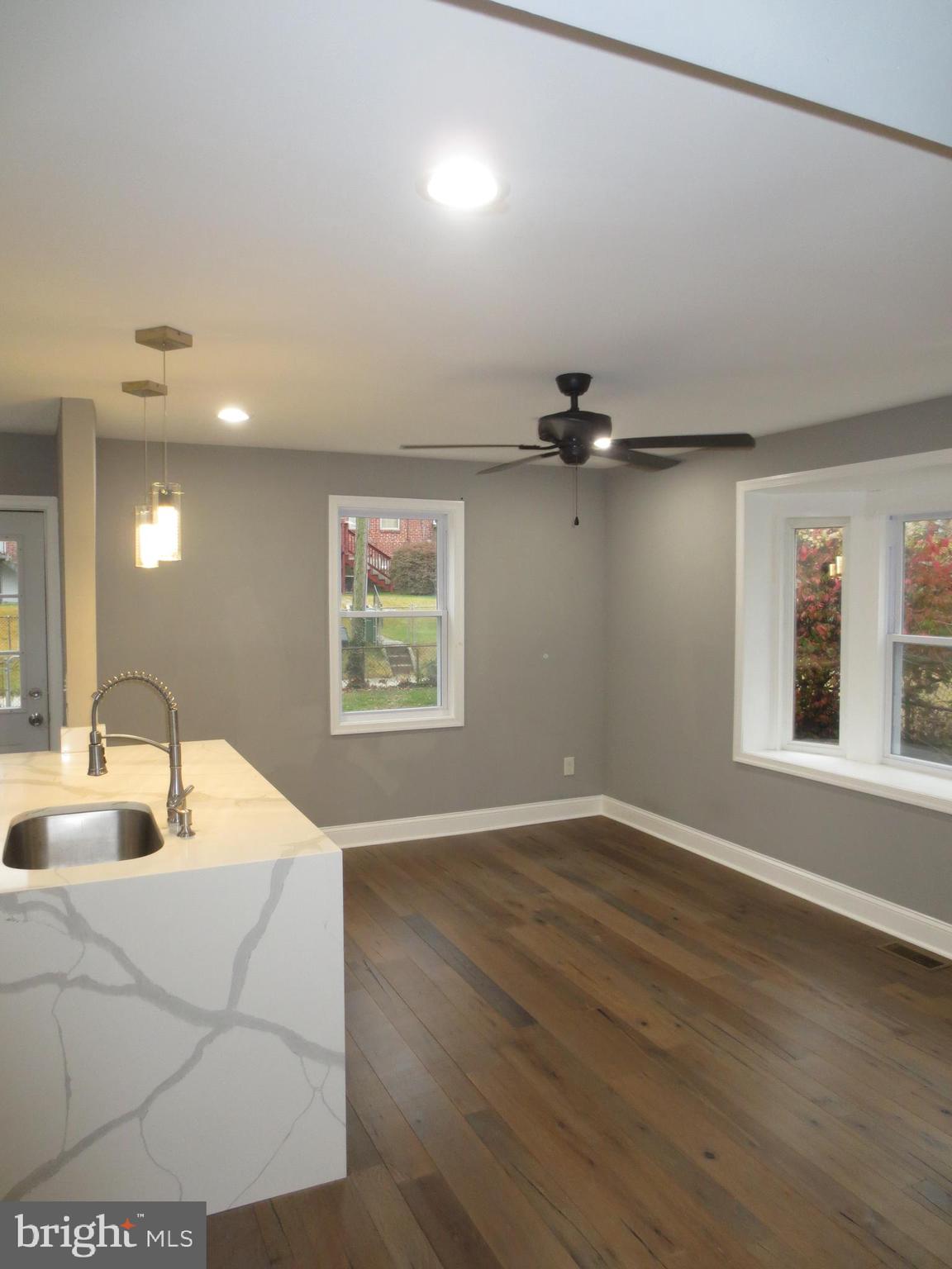 2027 Ramblewood Road Baltimore, MD 21239 - Photo 4 of 17 an empty room with windows and ceiling fan
