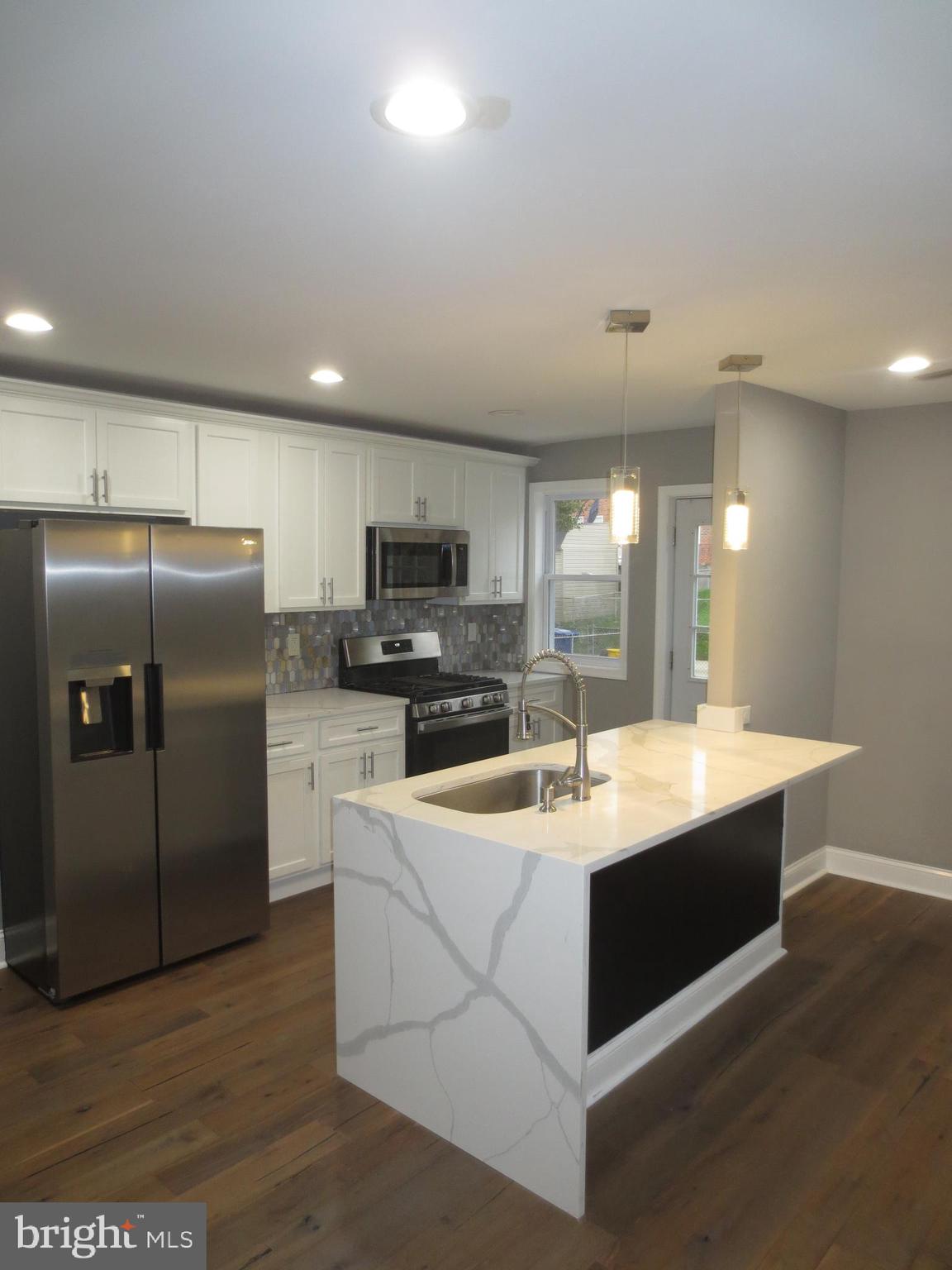 2027 Ramblewood Road Baltimore, MD 21239 - Photo 5 of 17 a kitchen with stainless steel appliances granite countertop a sink a stove a refrigerator and island
