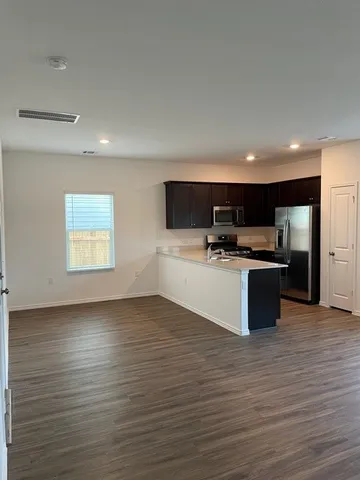 a kitchen with a refrigerator and a sink