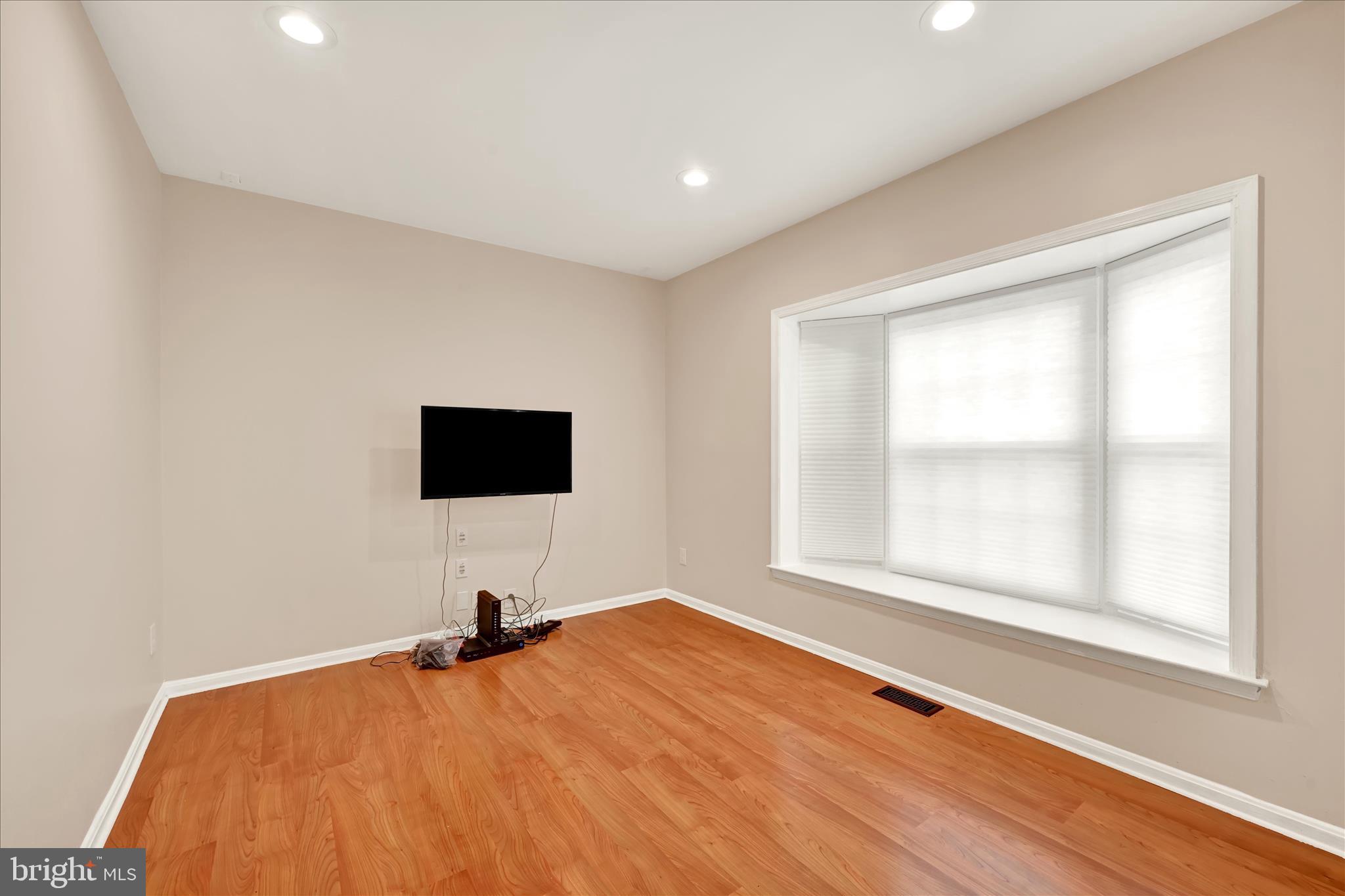 2317 Wonderview Road Lutherville-Timonium, MD 21093 - Photo 4 of 27 a bedroom with a bed and a flat screen tv