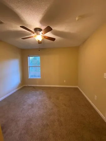 a view of an empty room with a windows