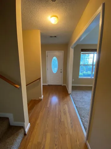 a kitchen with wooden floors and stainless steel appliances