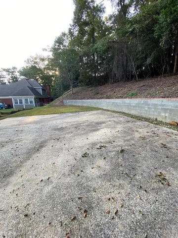 a view of a house with a yard and sitting area