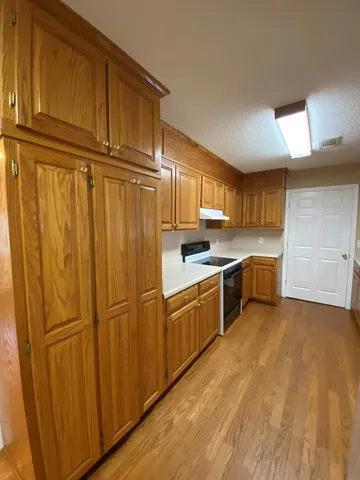 a kitchen with cabinets a sink and a refrigerator