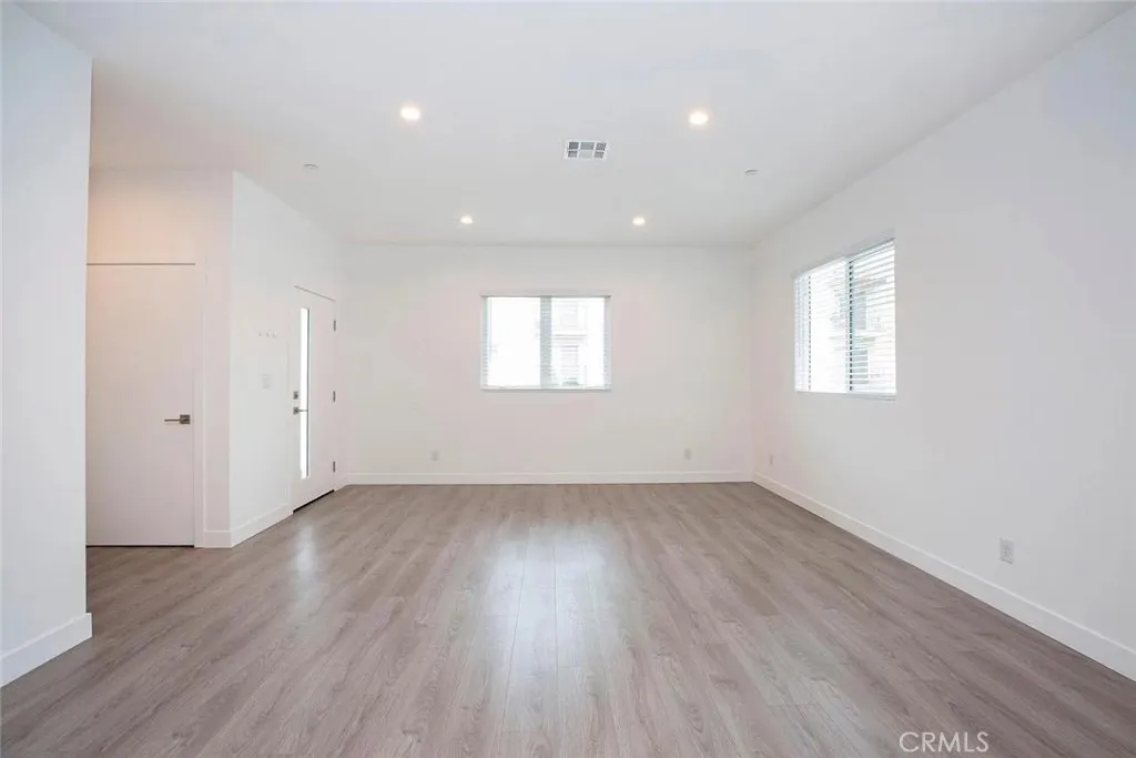 5026 Cleon Avenue North Hollywood, CA 91601 - Photo 12 of 19 an empty room with wooden floor and windows