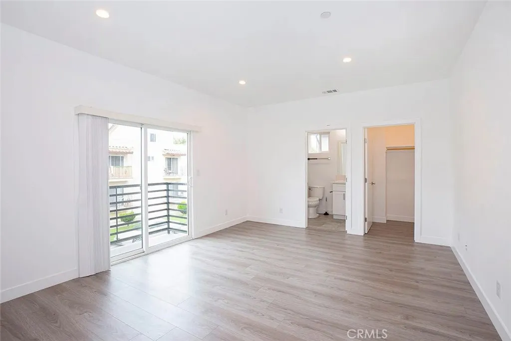 5026 Cleon Avenue North Hollywood, CA 91601 - Photo 14 of 19 an empty room with wooden floor and windows
