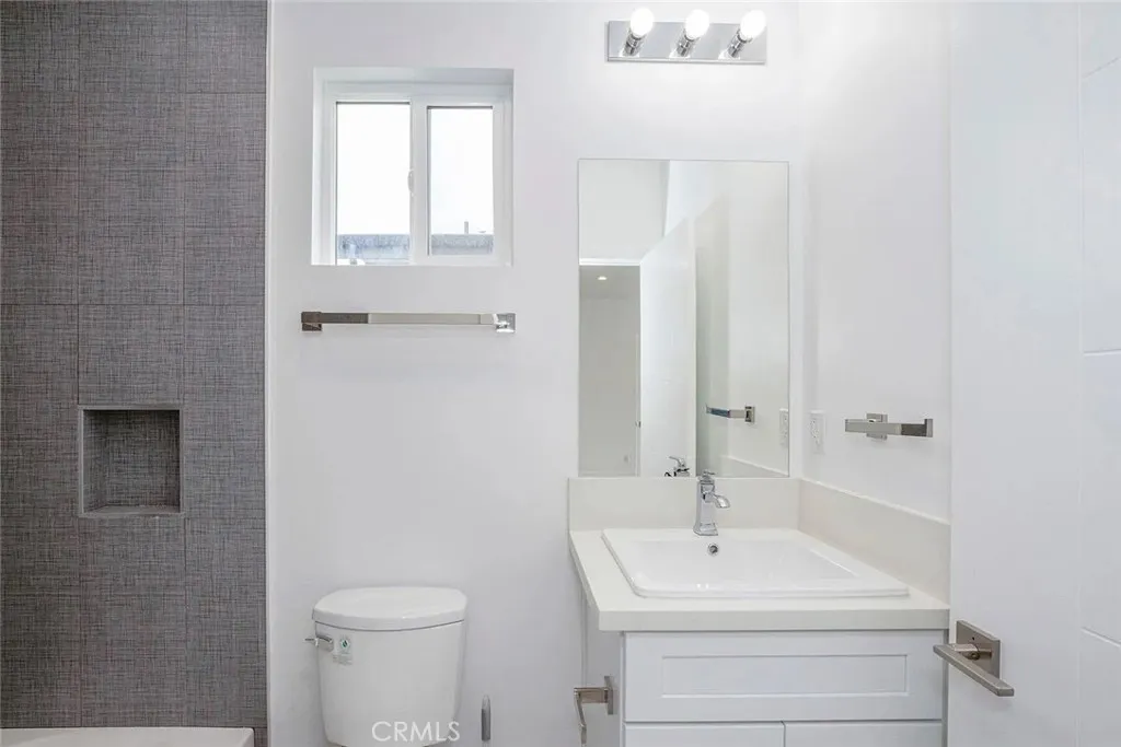 5026 Cleon Avenue North Hollywood, CA 91601 - Photo 17 of 19 a bathroom with a sink a toilet and a mirror
