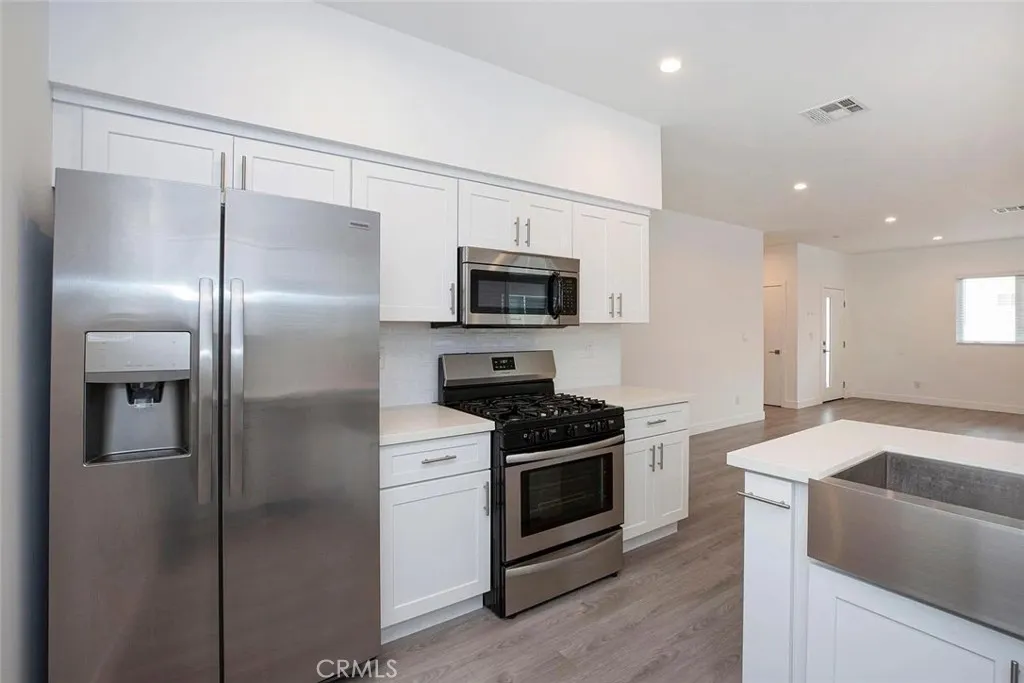 5026 Cleon Avenue North Hollywood, CA 91601 - Photo 4 of 19 a kitchen with a refrigerator sink and stove