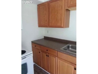 425 South 38th Street Springfield, OR 97478 - Photo 6 of 23 a kitchen with granite countertop cabinets stainless steel appliances and a sink