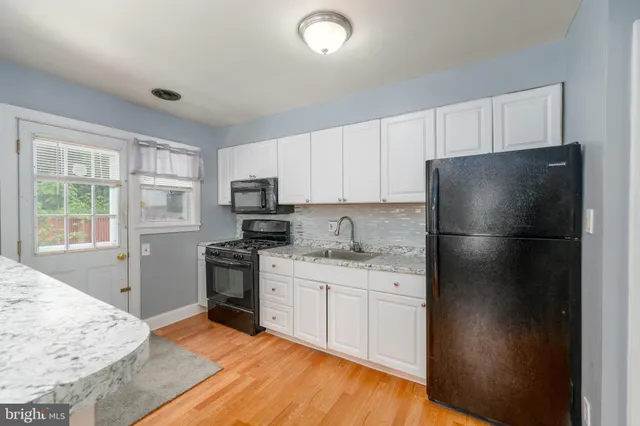 a kitchen with a refrigerator stove and sink