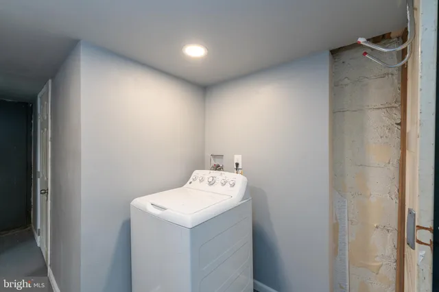 an empty room with windows and entrance to other room